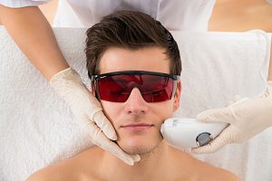 Beautician Giving Laser Epilation Treatment To Man Face